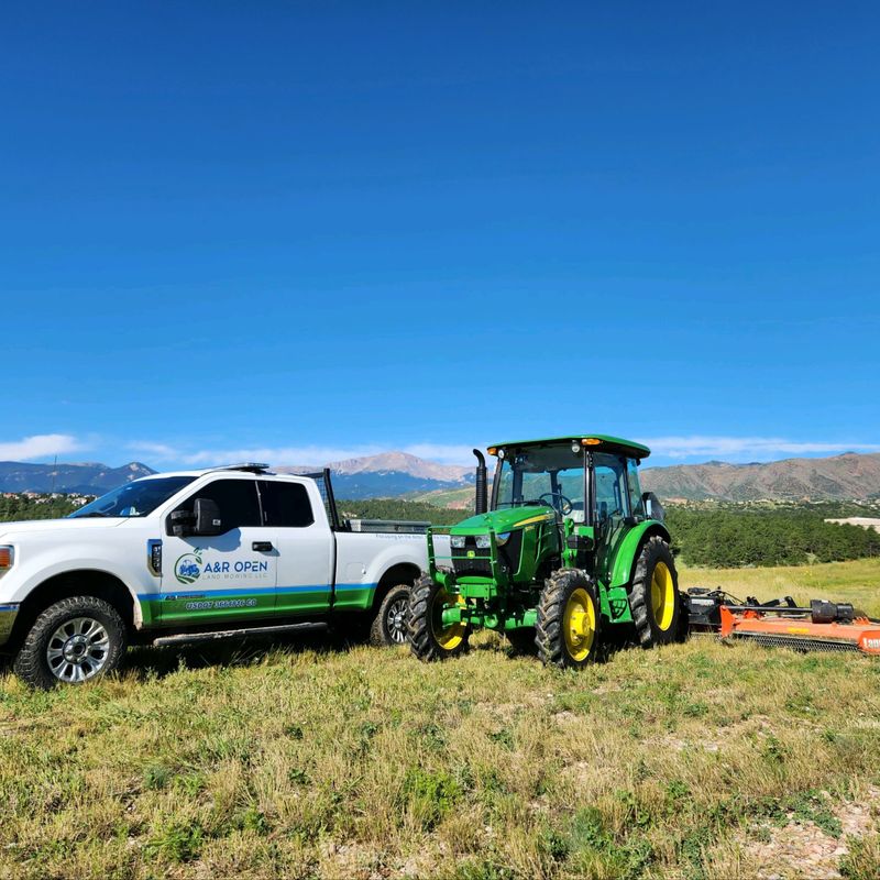 truck and field mowing tractor